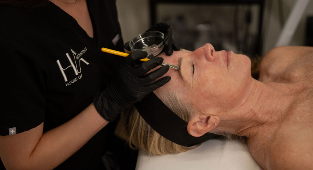 Close-up of a patient's perfectly shaped and lifted eyebrows after a brow lamination and tinting service at House of Aesthetics.